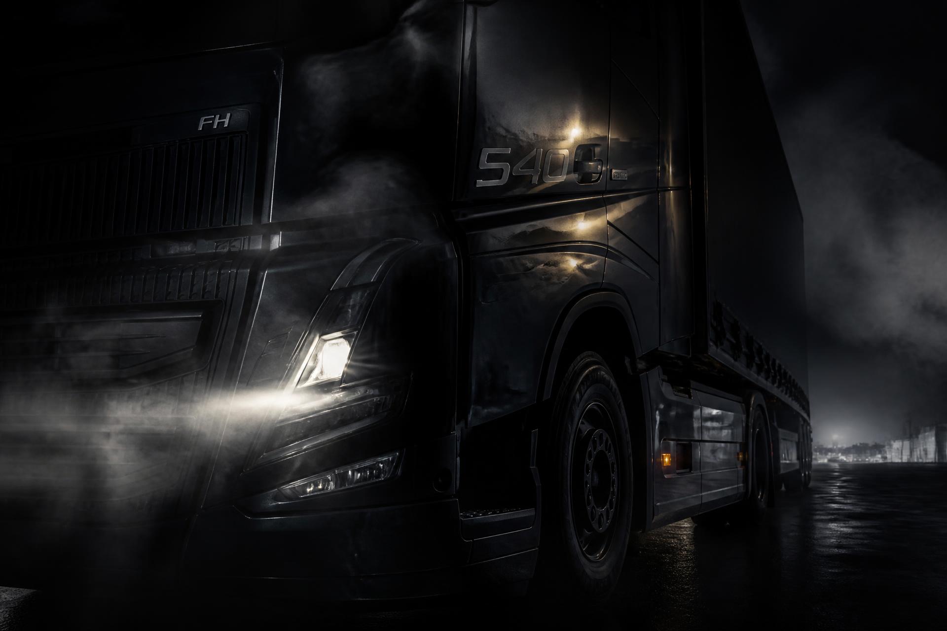 Freight truck at night with headlights cutting through fog on a South African highway